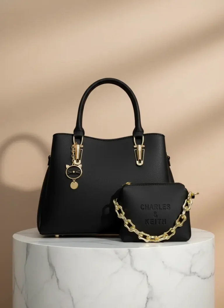 Black 2-piece handbag set with matching small pouch by Elixir Bags on beige background.