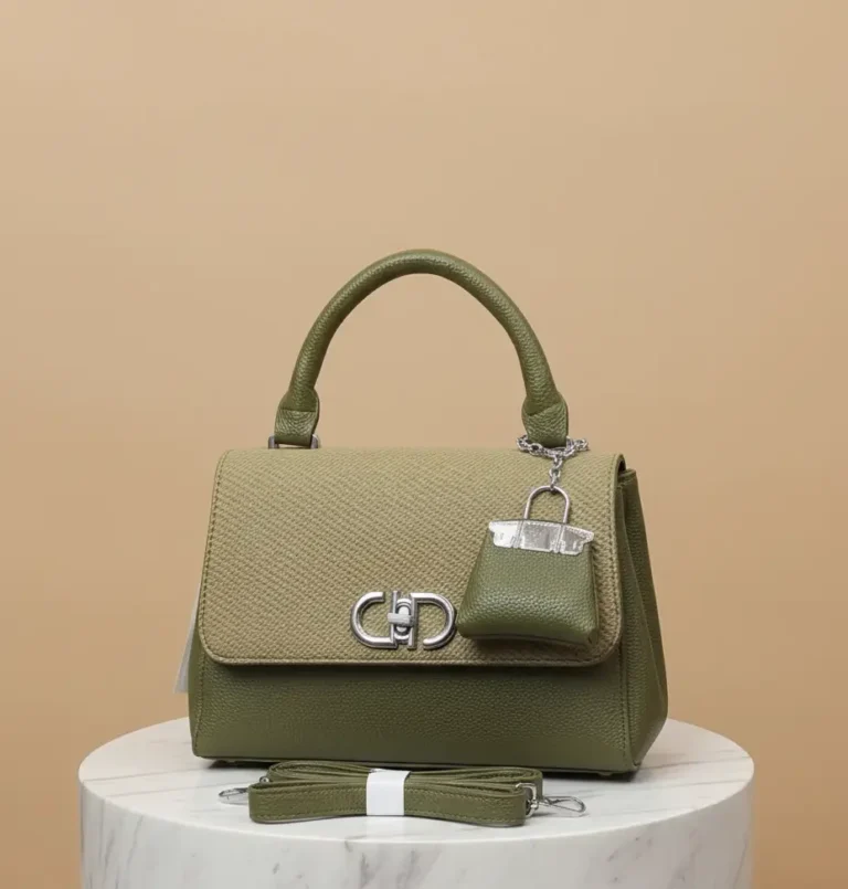 green cross body handbag with beautiful keychain and long strap